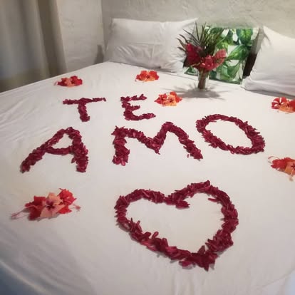 Rose petal bed decoration spelling out a romantic message