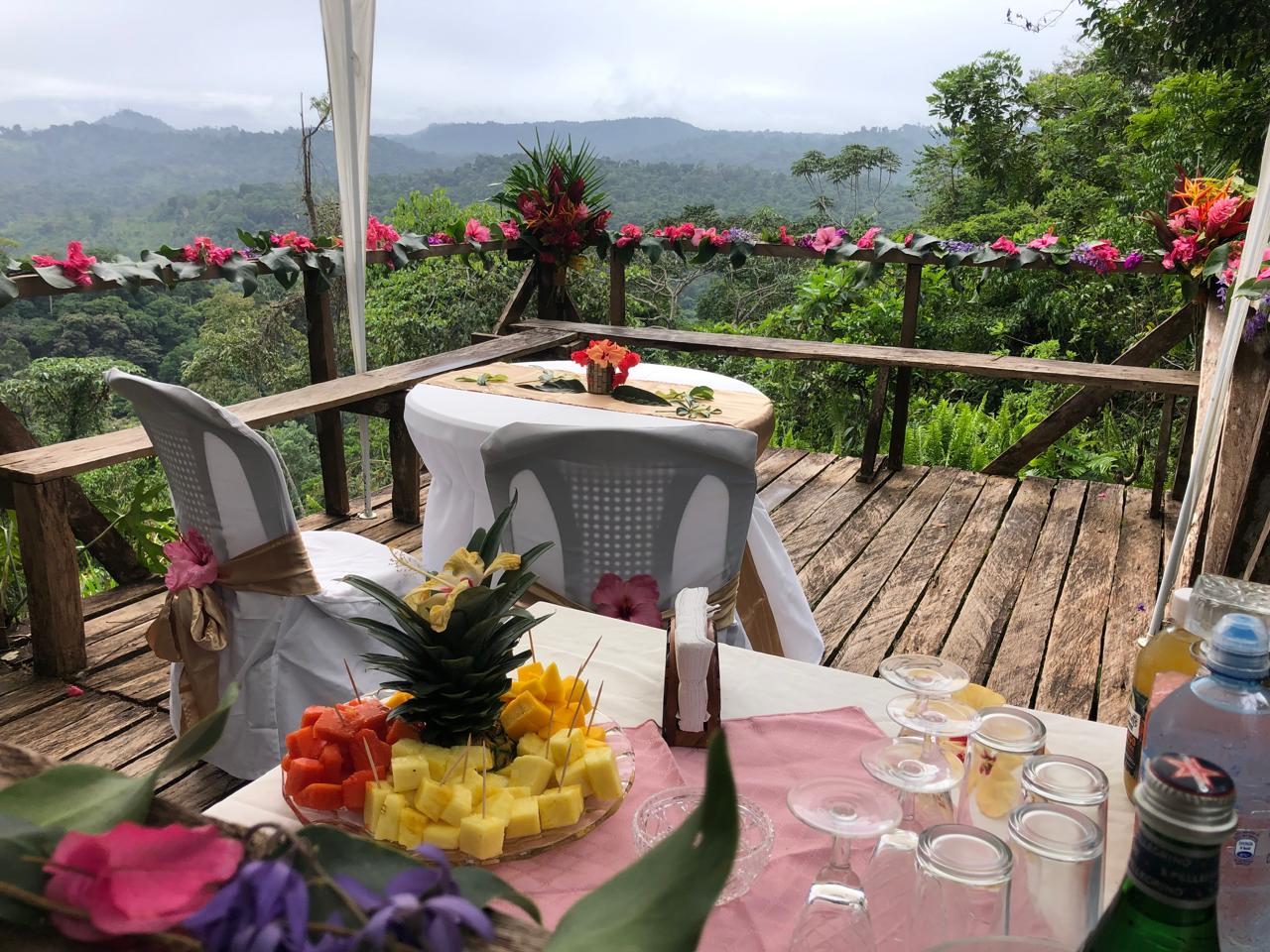 Jungle wedding table with mountain views and tropical flower garlands